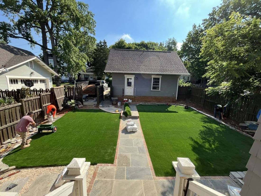 Backyard after: new turf and bluestone walk, crew finishing the install