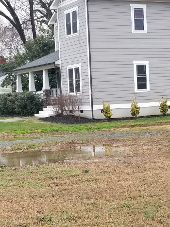 French drain installation in progress in a Charlotte backyard