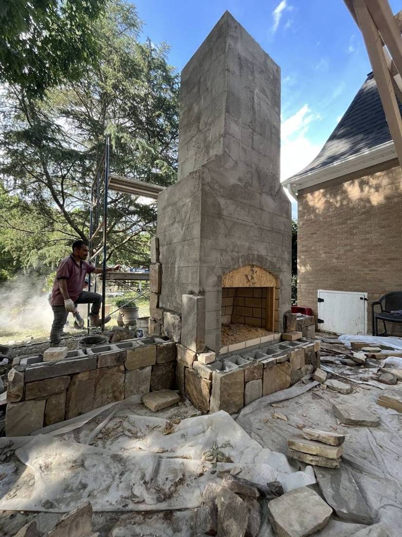 Scratch coat on chimney with natural stone going on the base