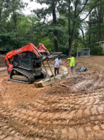 Boulder retaining wall installation and site grading