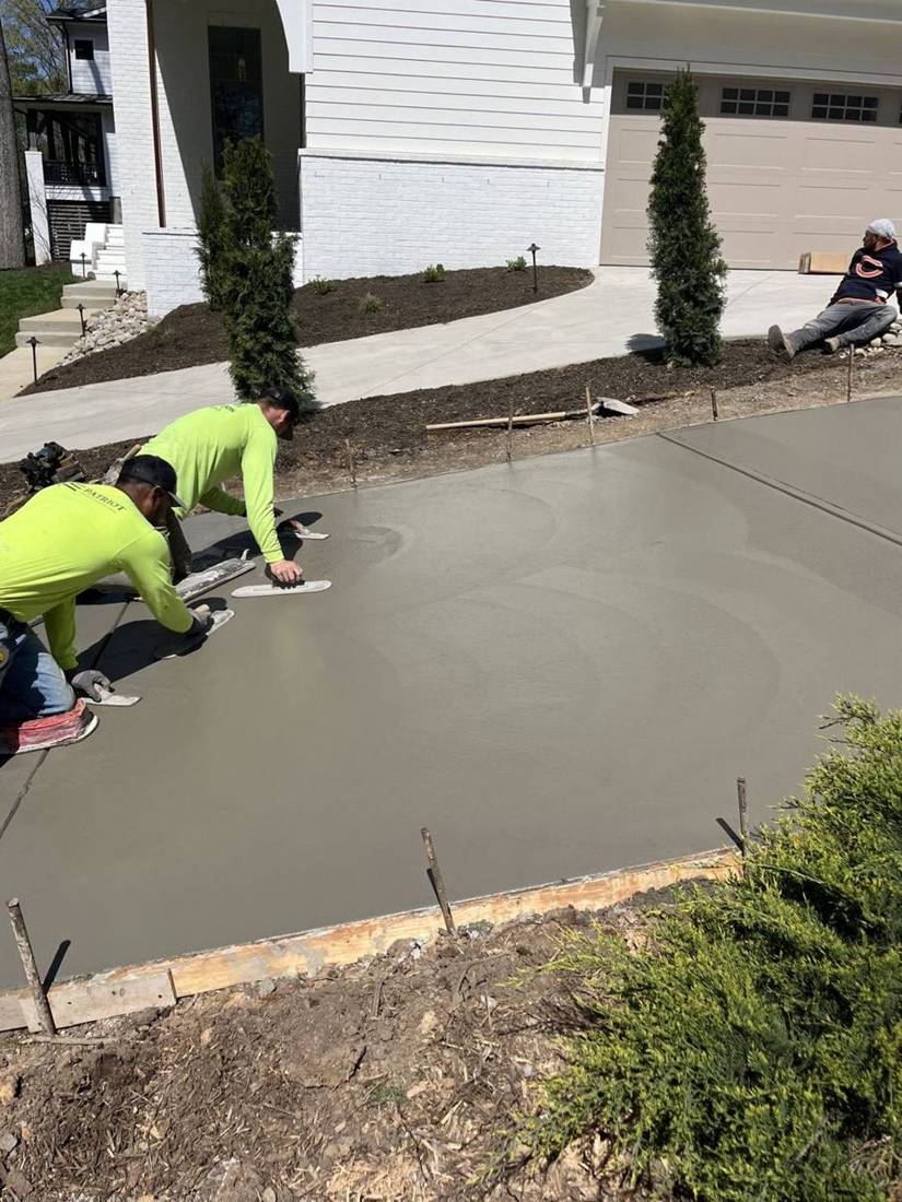 Crew hand-troweling fresh concrete