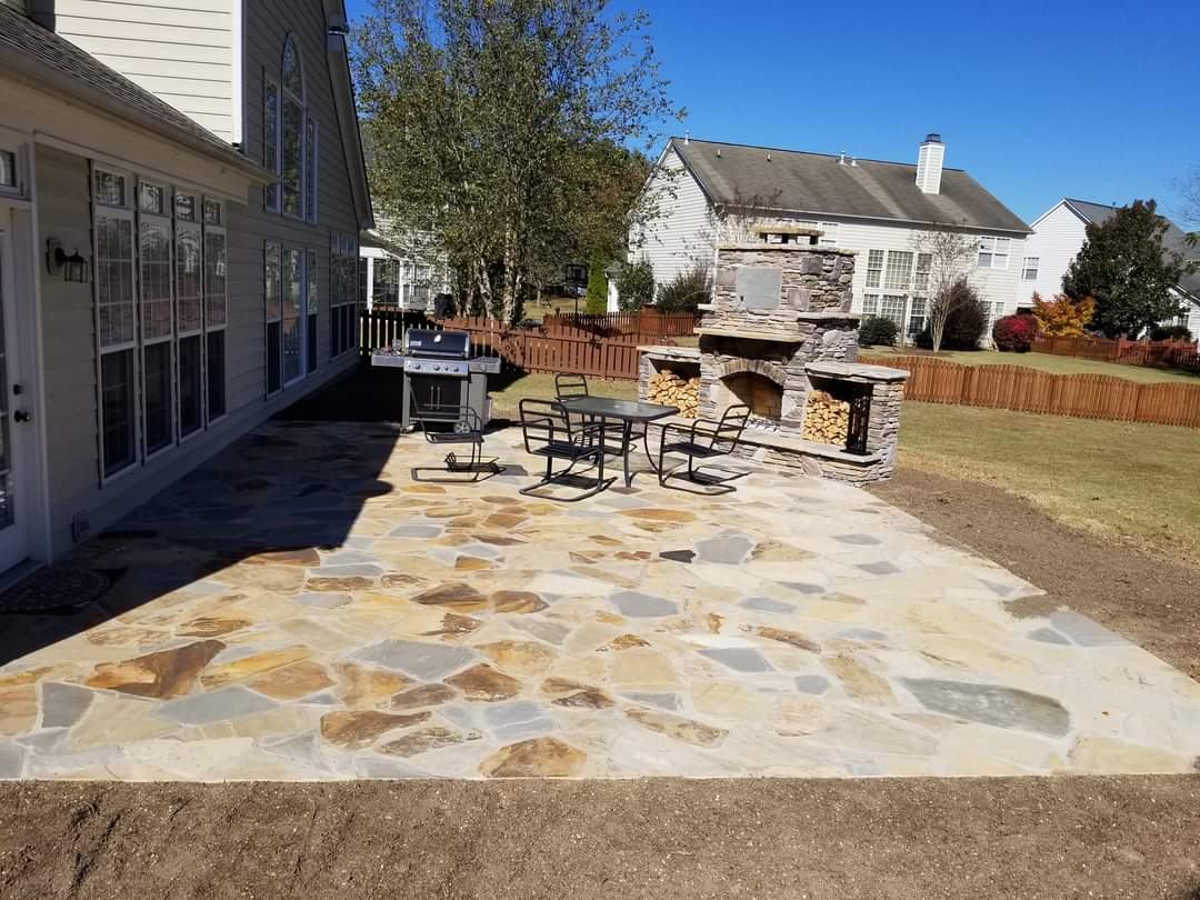 Flagstone patio with a stacked-stone outdoor fireplace