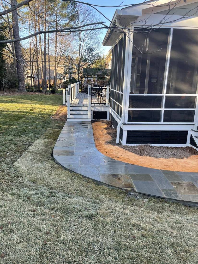 Curved flagstone walkway leading to deck stairs