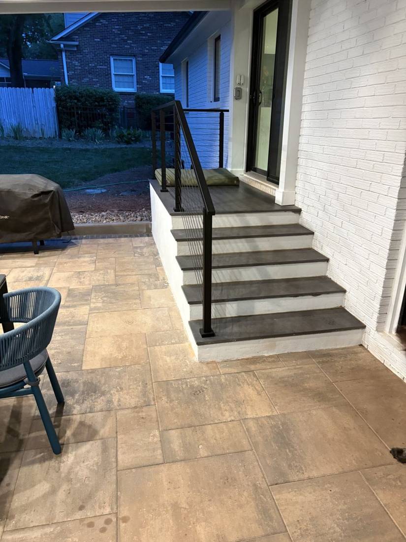 Paver patio at the foot of porch steps