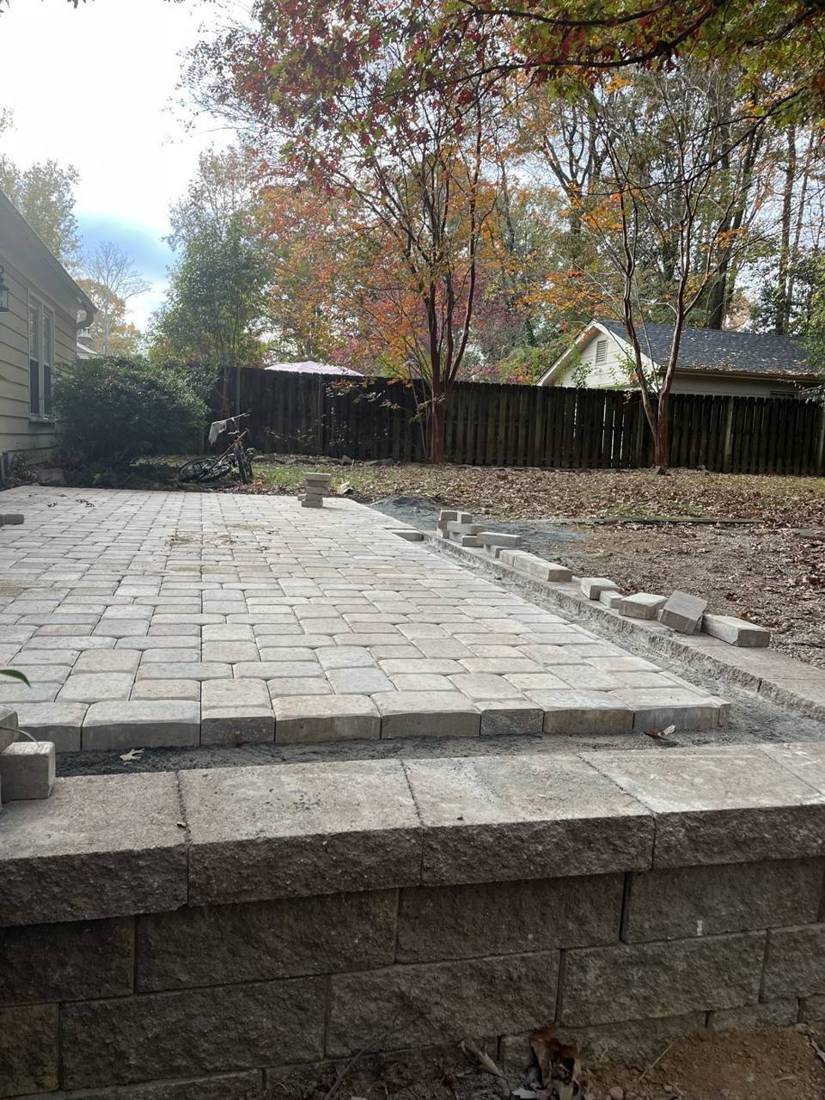Raised paver patio on a block wall, nearly finished