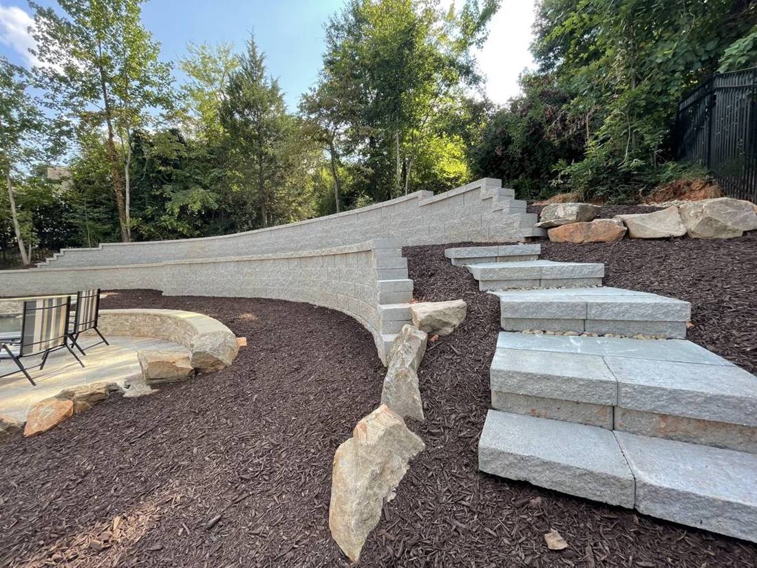 Finished block steps and boulders between terraced walls